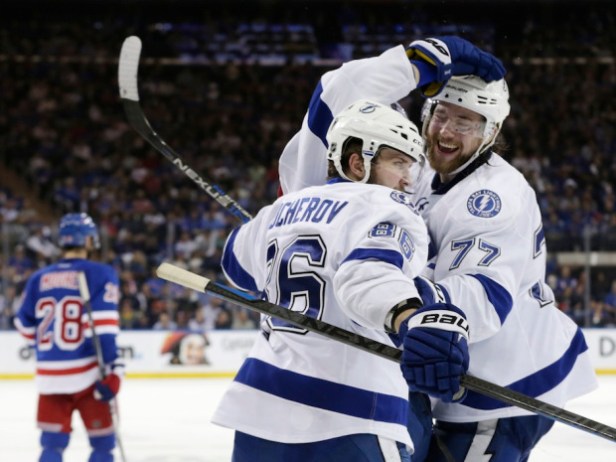 Tampa Bay Lightning right wing Nikita Kucherov (86) and Tampa Bay Lightning defenseman Victor Hedman (77) celebrate a third period goal by left wing Ondrej Palat (18) against the New York Rangers during Game 7 of the Eastern Conference final during the NHL hockey Stanley Cup playoffs, Friday, May 29, 2015, in New York. (AP Photo/Frank Franklin)